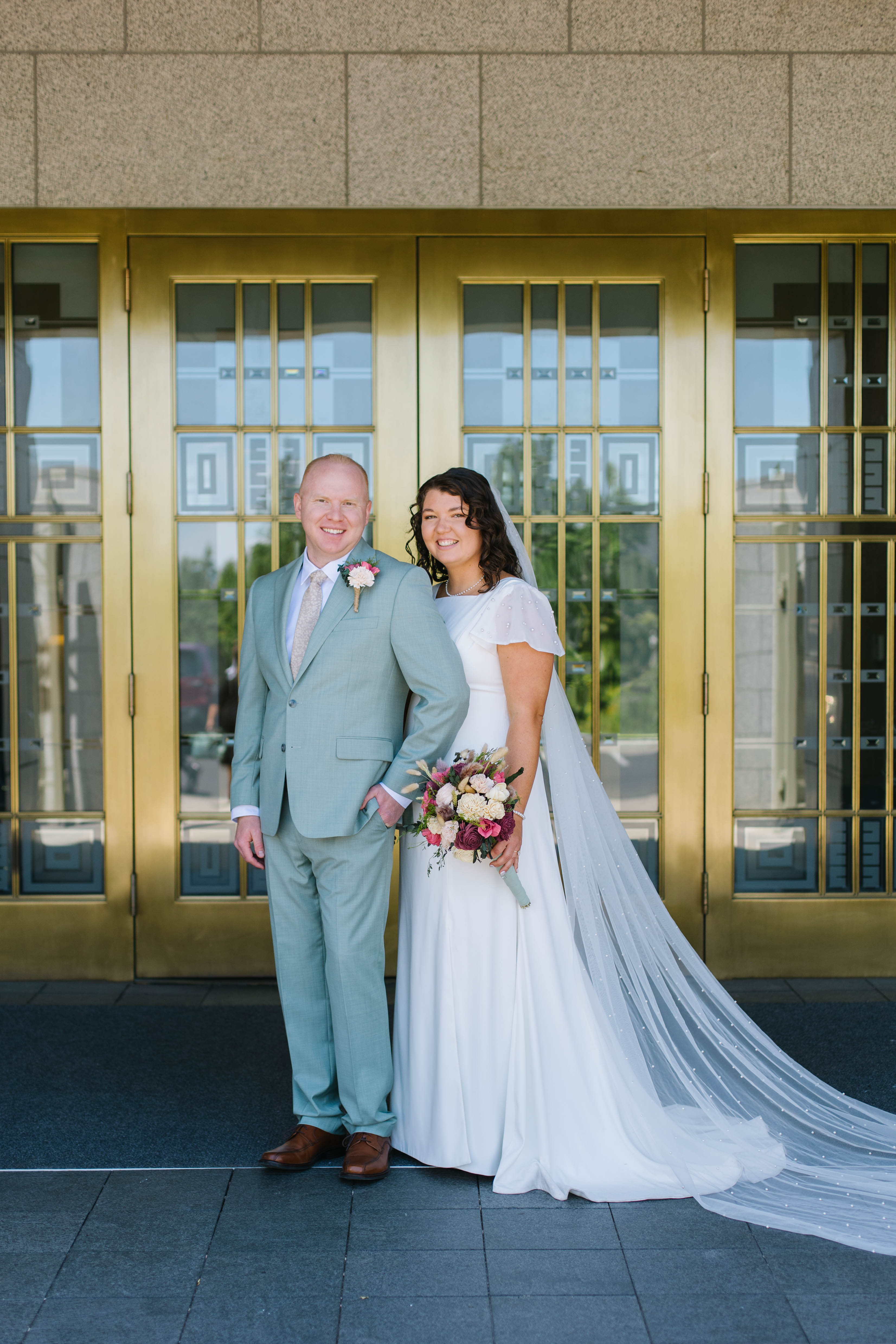 Sydney and Bryan in front of the temple's gold doors on their wedding day